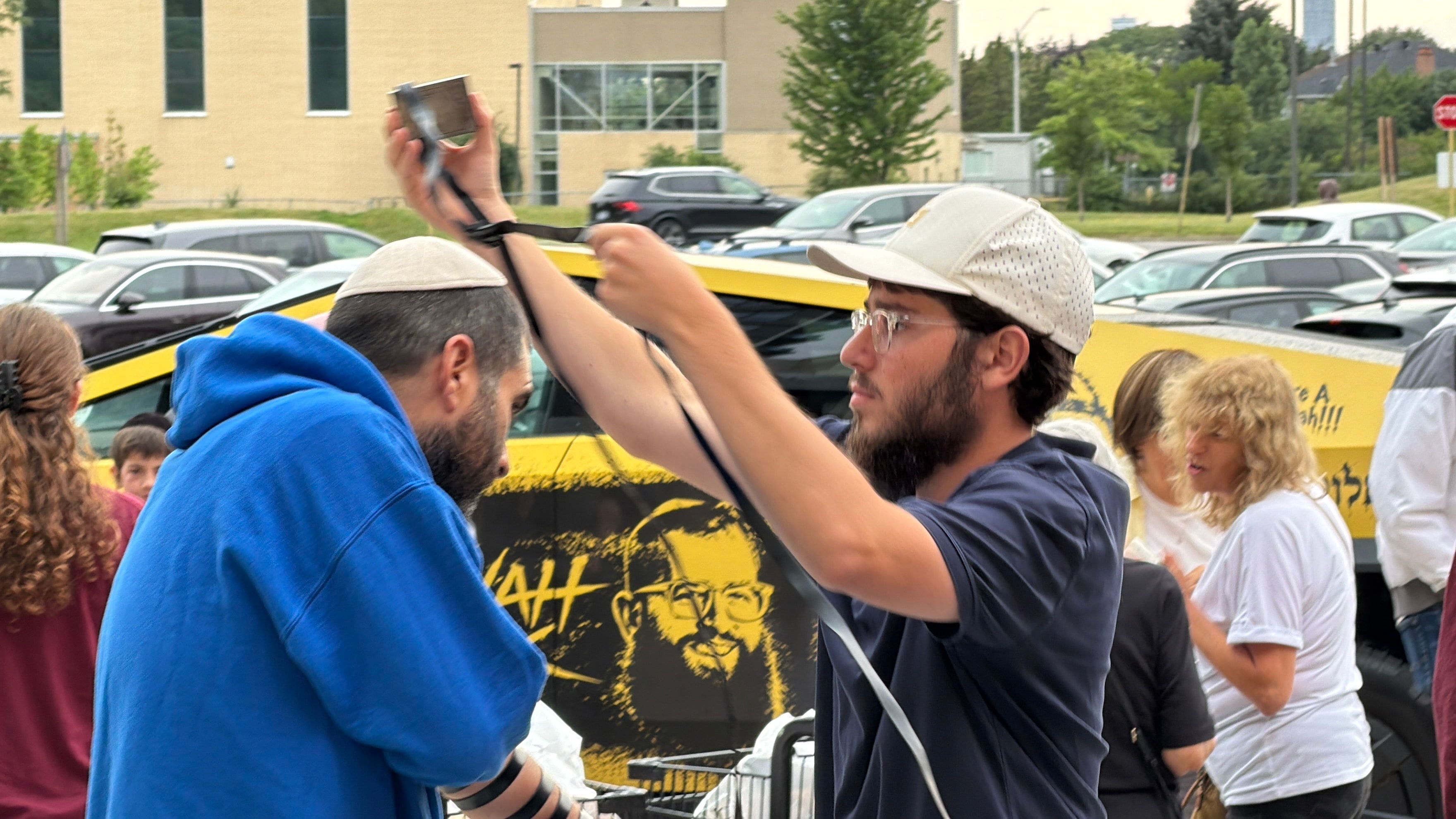 Wrapping tefillin at a Mitzvah Truck stop
